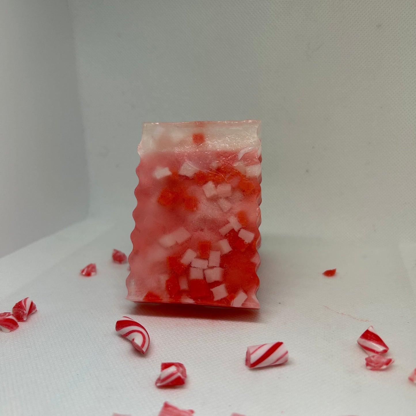 Peppermint-scented Frosted Cane soap with festive red and white candy pieces, perfect for holiday gifting and skincare.