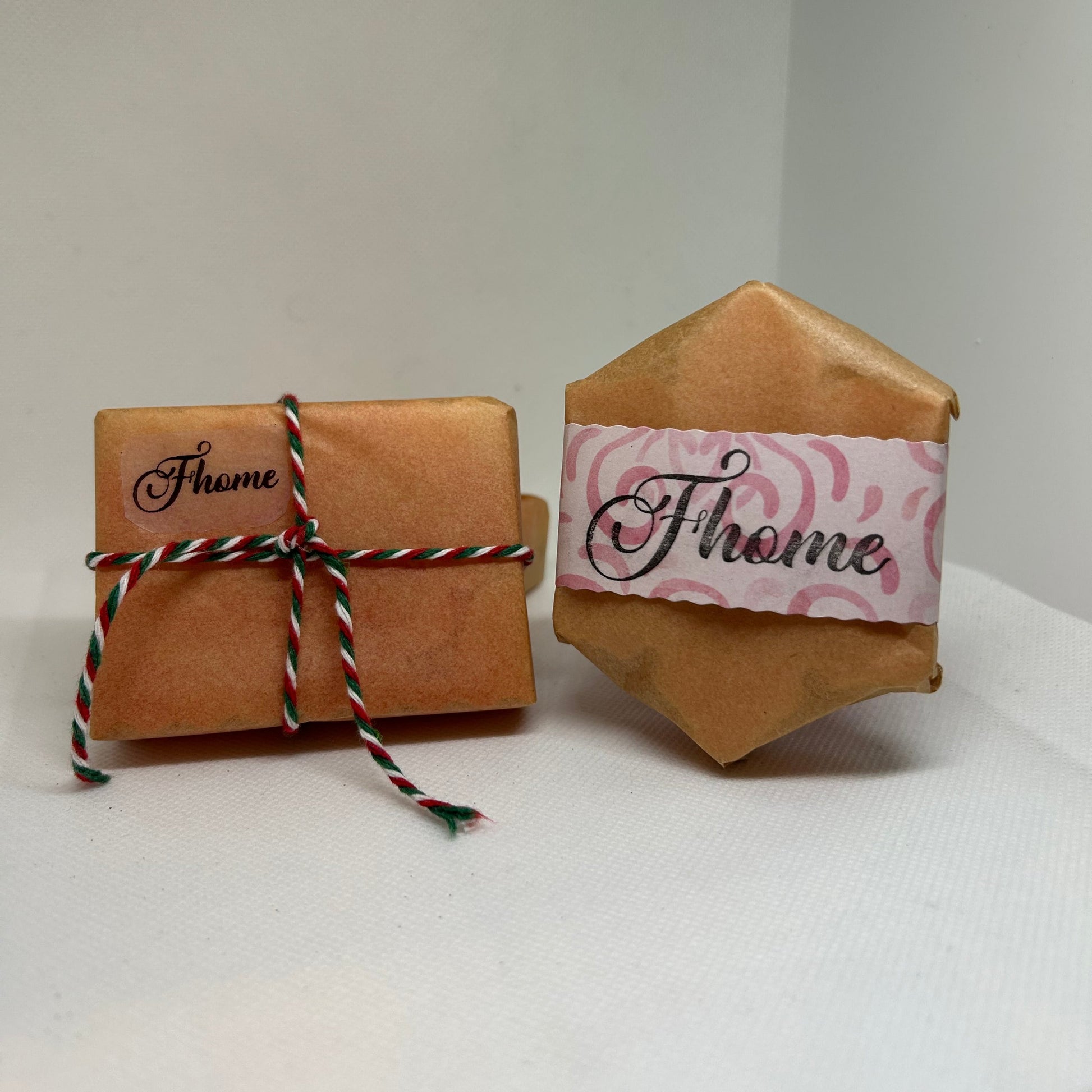 Two beautifully wrapped handmade soaps with decorative labels, perfect for a holiday gift or special occasion.